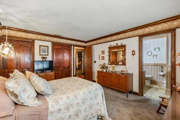 a bedroom with a bed and dresser