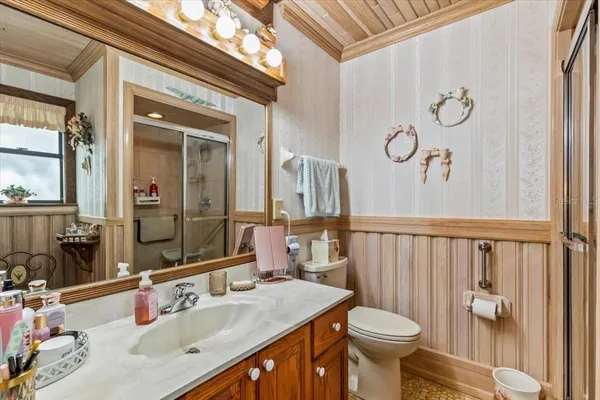 a bathroom with a sink toilet and mirror