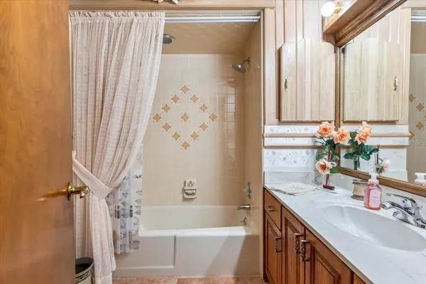 a bathroom with a sink a bathtub and a window