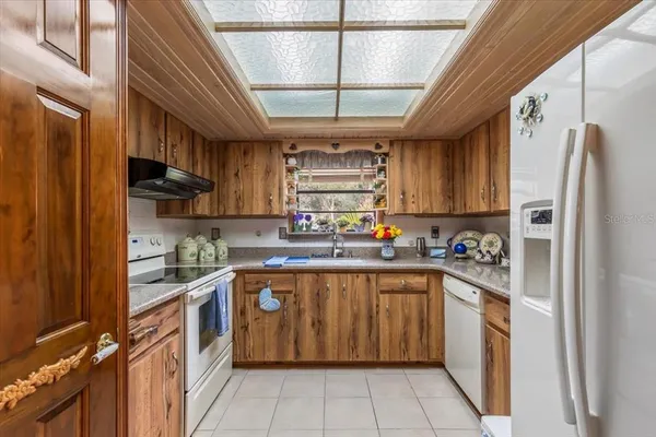 a kitchen with stainless steel appliances granite countertop a refrigerator and a stove