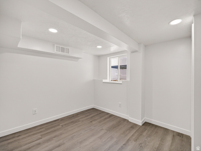 74 South 300 East Springville, UT 84663 - Photo 22 of 48 Interior room featuring wood-finish flooring, recessed ceiling lighting, a single window, white baseboards, and white walls
