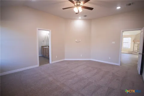 an empty room with closet and windows