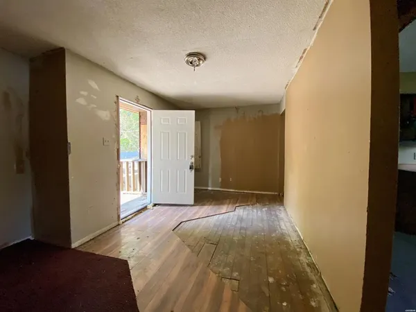 a view of a livingroom with wooden floor and a window