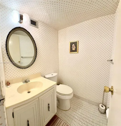 a kitchen with cabinets a sink and white appliances
