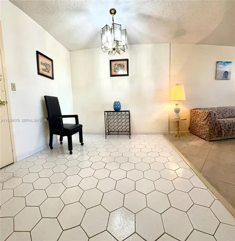 a living room with furniture a dining table and a potted plant