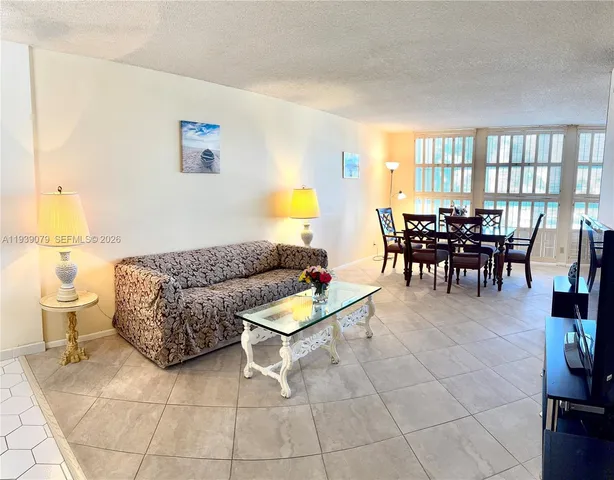 a living room with furniture and kitchen view