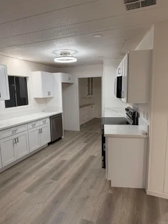 a kitchen with wooden cabinets and a stove