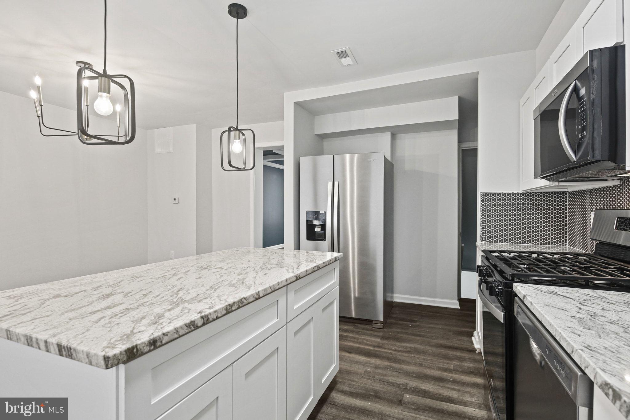 1322 Kitmore Road Baltimore, MD 21239 - Photo 11 of 34 a kitchen with kitchen island granite countertop stainless steel appliances a stove oven and cabinets
