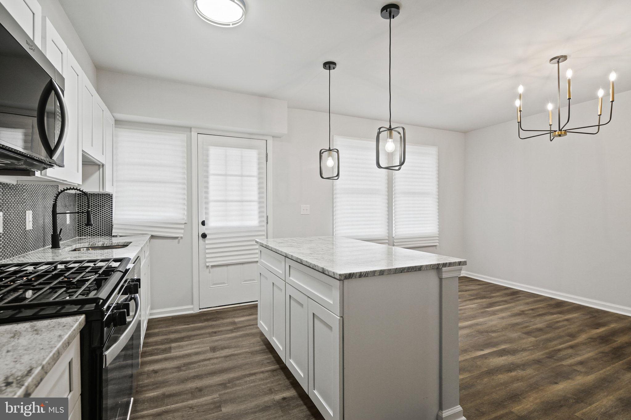 1322 Kitmore Road Baltimore, MD 21239 - Photo 12 of 34 a kitchen with a refrigerator a sink and wooden floor