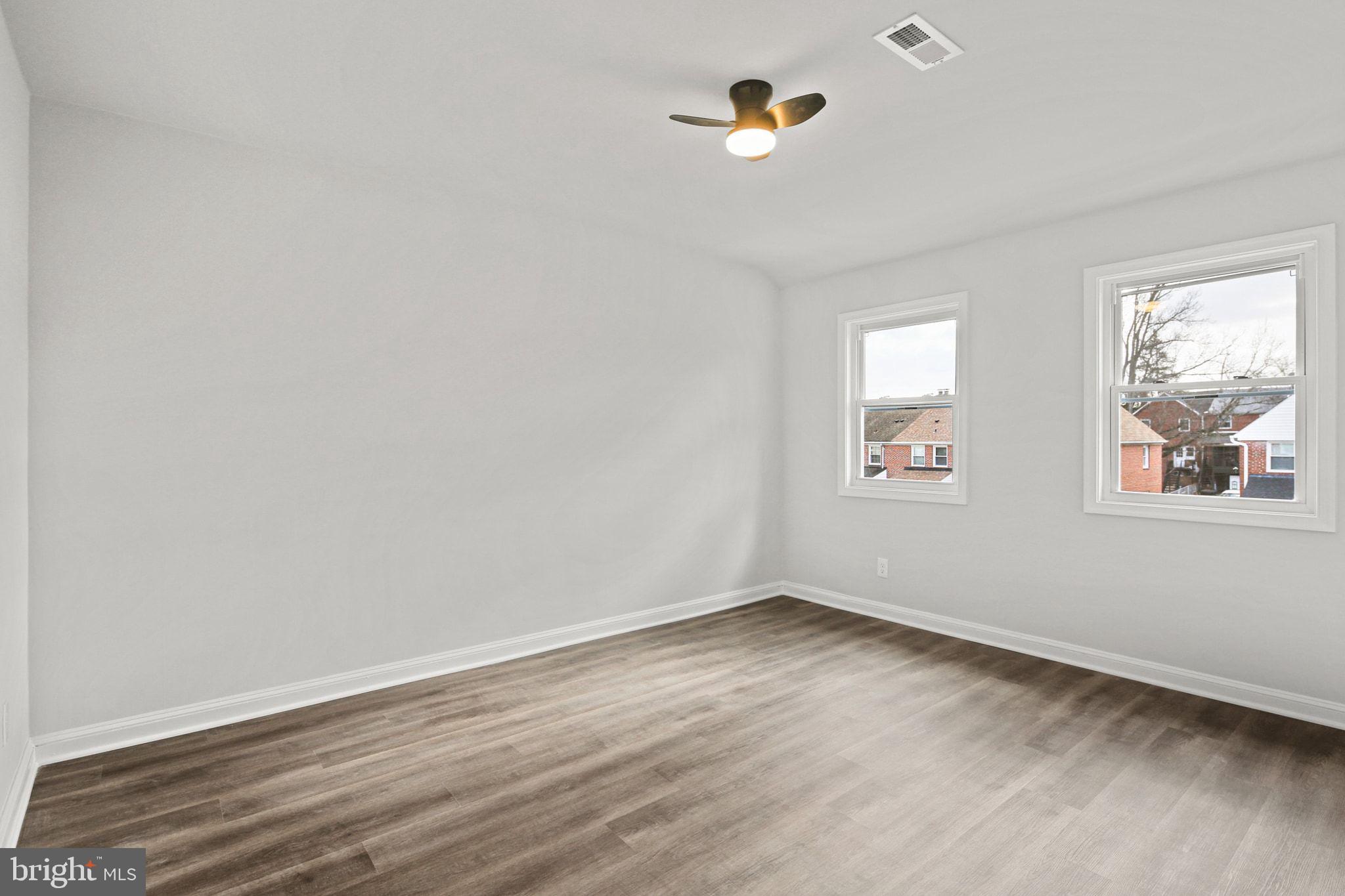 1322 Kitmore Road Baltimore, MD 21239 - Photo 16 of 34 wooden floor in an empty room with a window