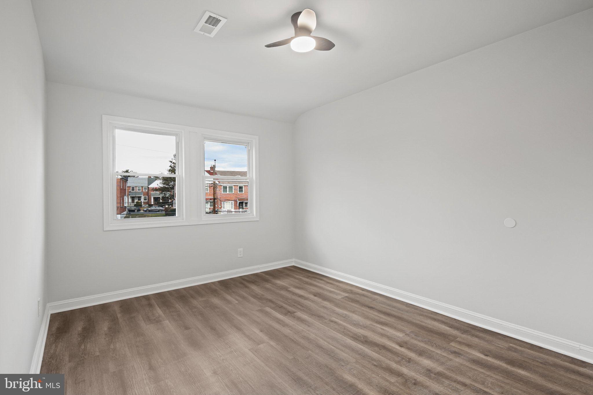 1322 Kitmore Road Baltimore, MD 21239 - Photo 19 of 34 wooden floor in an empty room with a window