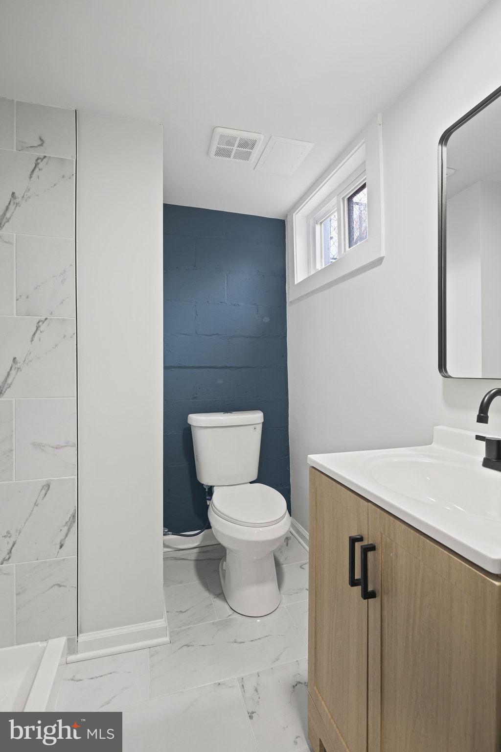 1322 Kitmore Road Baltimore, MD 21239 - Photo 30 of 34 a white toilet sitting next to a bathroom sink