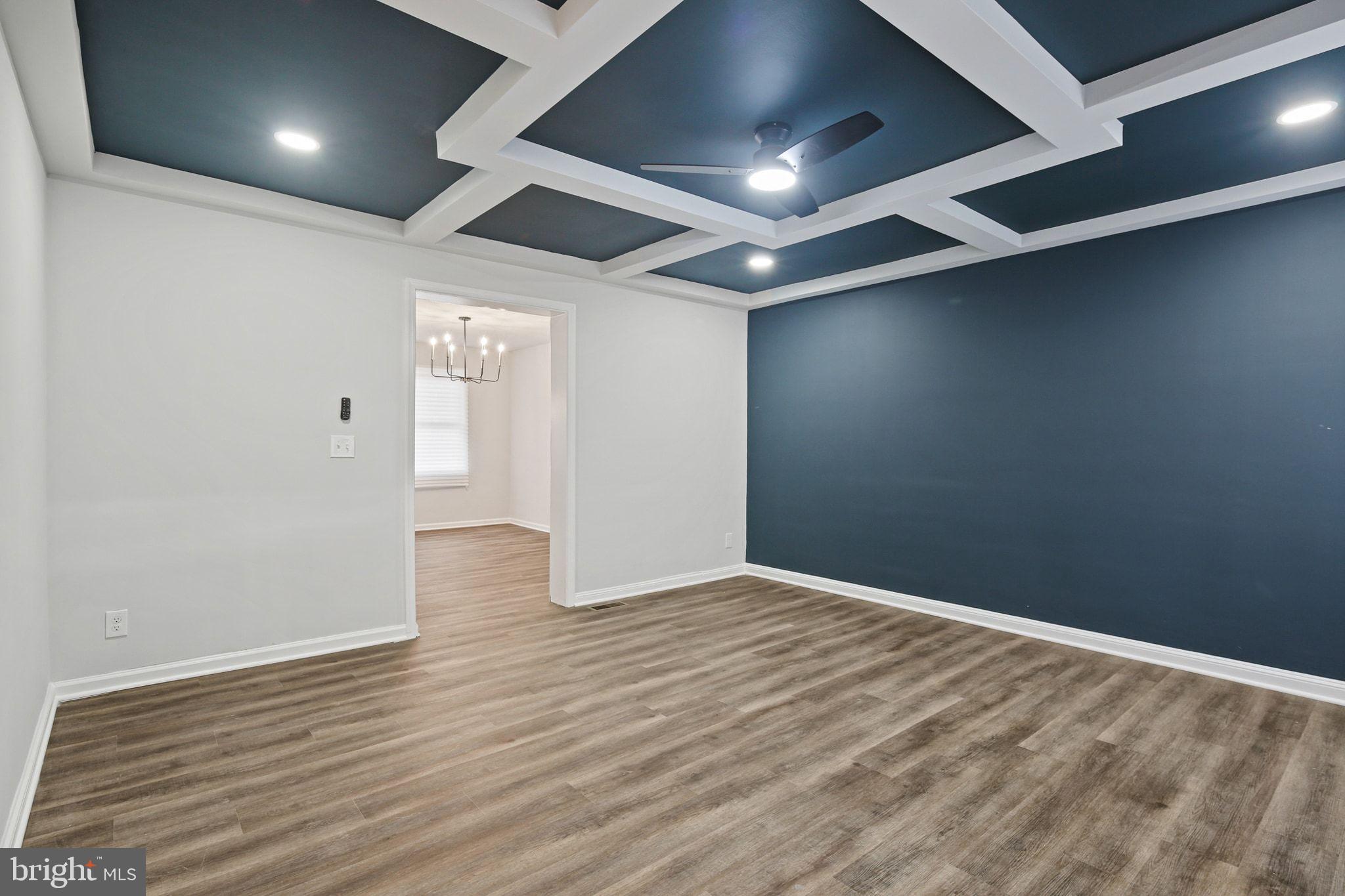 1322 Kitmore Road Baltimore, MD 21239 - Photo 4 of 34 an empty room with wooden floor and windows