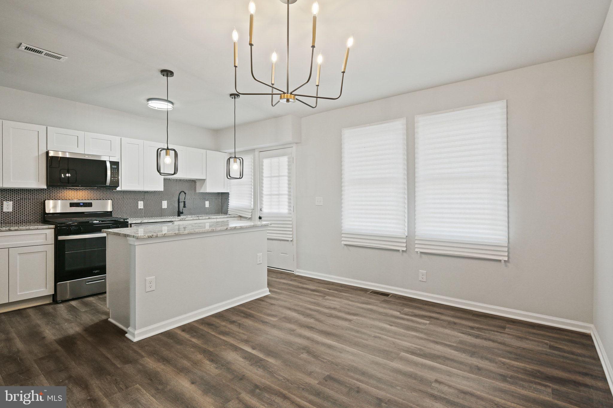 1322 Kitmore Road Baltimore, MD 21239 - Photo 9 of 34 a kitchen with granite countertop a stove a sink and a microwave