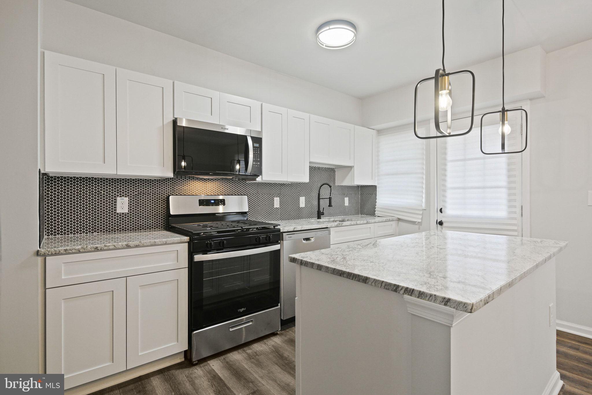 1322 Kitmore Road Baltimore, MD 21239 - Photo 10 of 34 a kitchen with a sink stove and microwave
