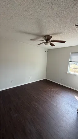 a view of a room with wooden floor and a window