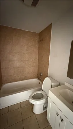a bathroom with a toilet a sink and bathtub