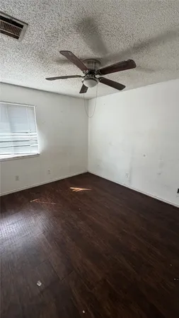 a view of a room with wooden floor and windows