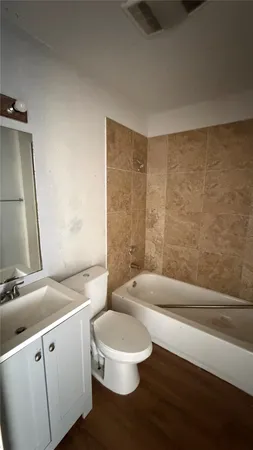 a bathroom with a toilet a sink and bathtub