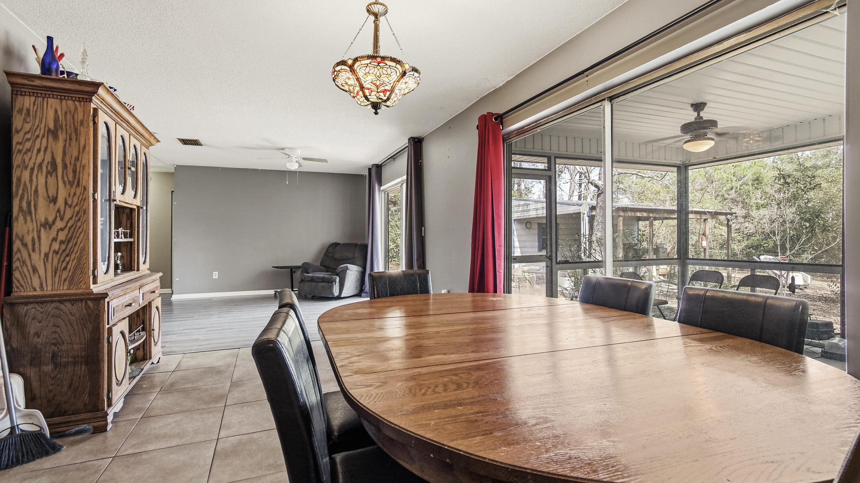 4335 Country Club Boulevard Chipley, FL 32428 - Photo 20 of 28 a view of a dining room with furniture wooden floor and chandelier