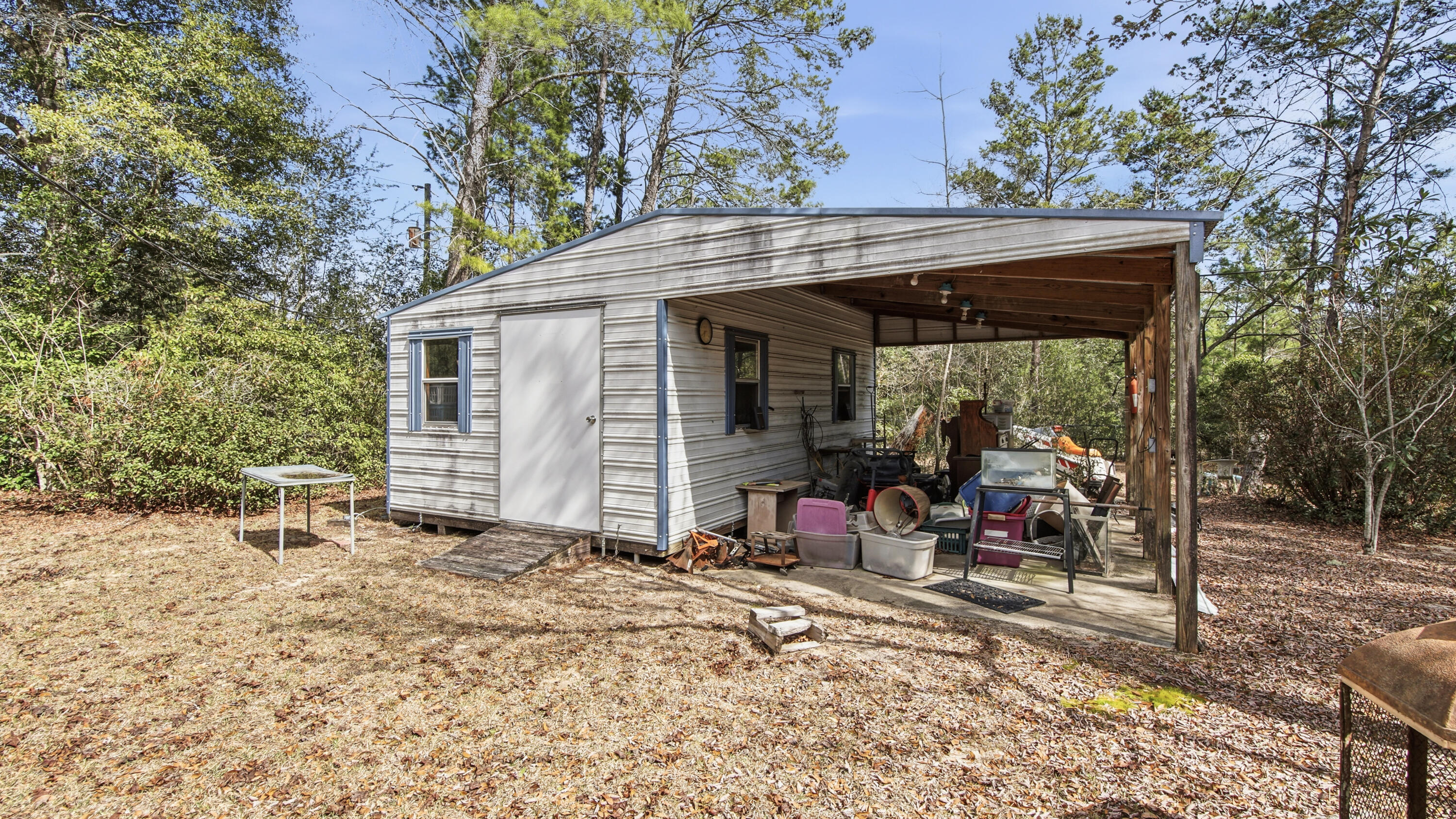 4335 Country Club Boulevard Chipley, FL 32428 - Photo 22 of 28 a view of a chair and table in backyard of the house