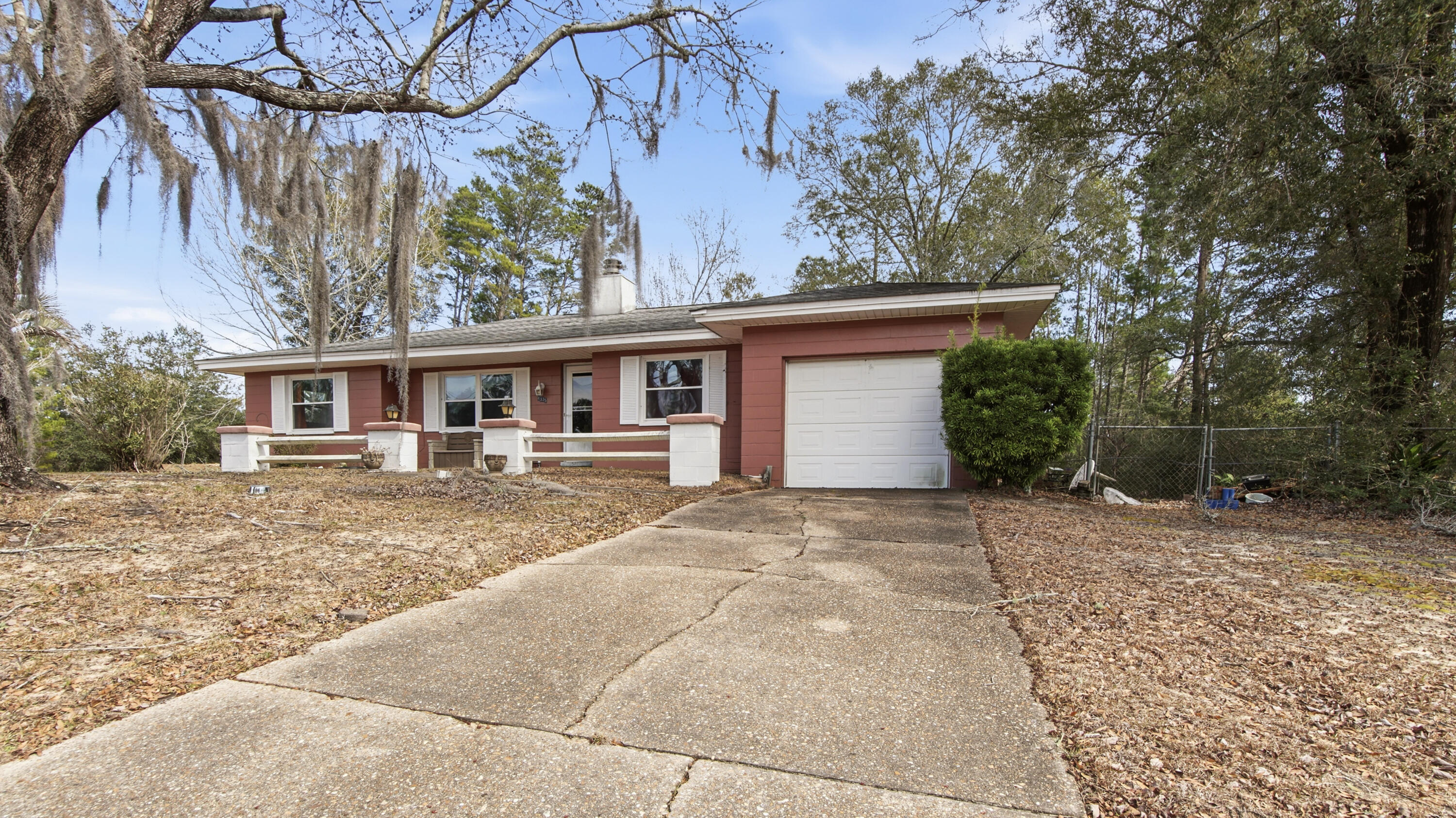 4335 Country Club Boulevard Chipley, FL 32428 - Photo 6 of 28 a front view of a house with a yard and garage