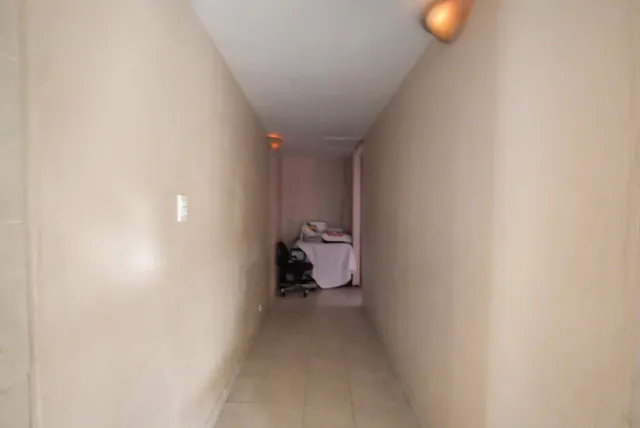 a view of a hallway with wooden shelves