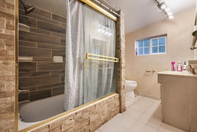 a bathroom with a bathtub and a shower