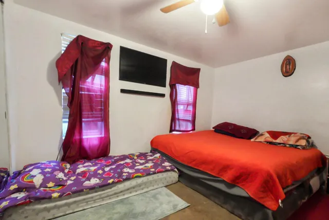 a bedroom with a bed and a dresser