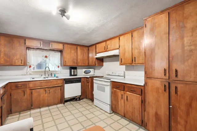 a kitchen with a sink stove and cabinets