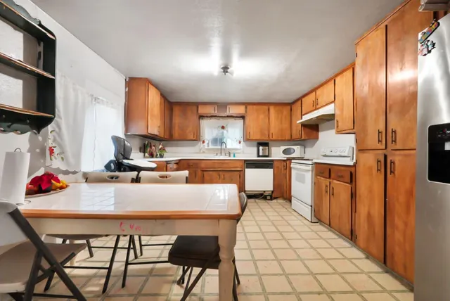 a kitchen with stainless steel appliances kitchen island granite countertop a sink and cabinets