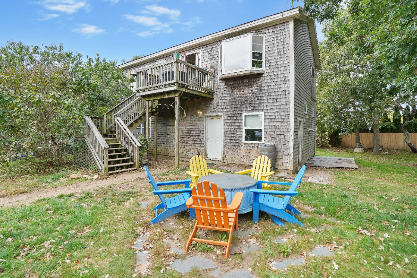 7 Martha's Way Edgartown, MA 02539 - Photo 3 of 13 a backyard of a house with table and chairs