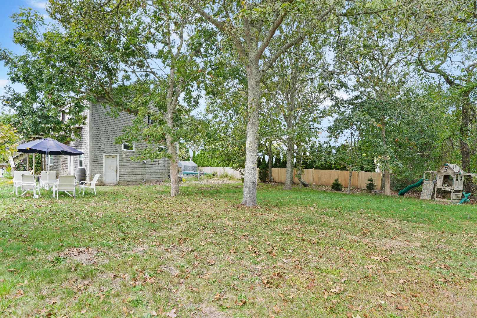 7 Martha's Way Edgartown, MA 02539 - Photo 6 of 13 a backyard of a house with entertaining space and deck