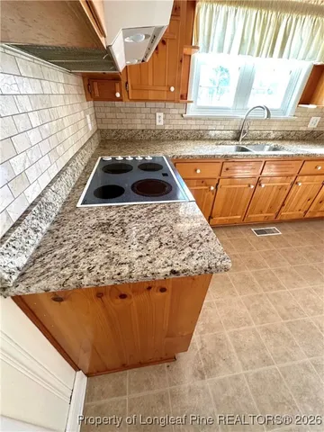 a view of a kitchen island with a sink