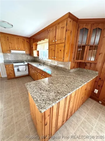 a view of a kitchen with a sink and cabinets