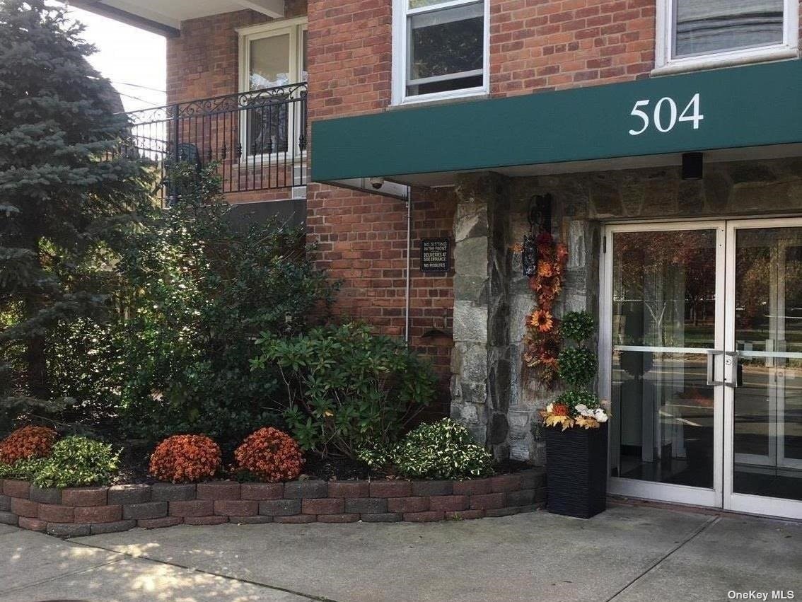 a front view of a building with potted plants