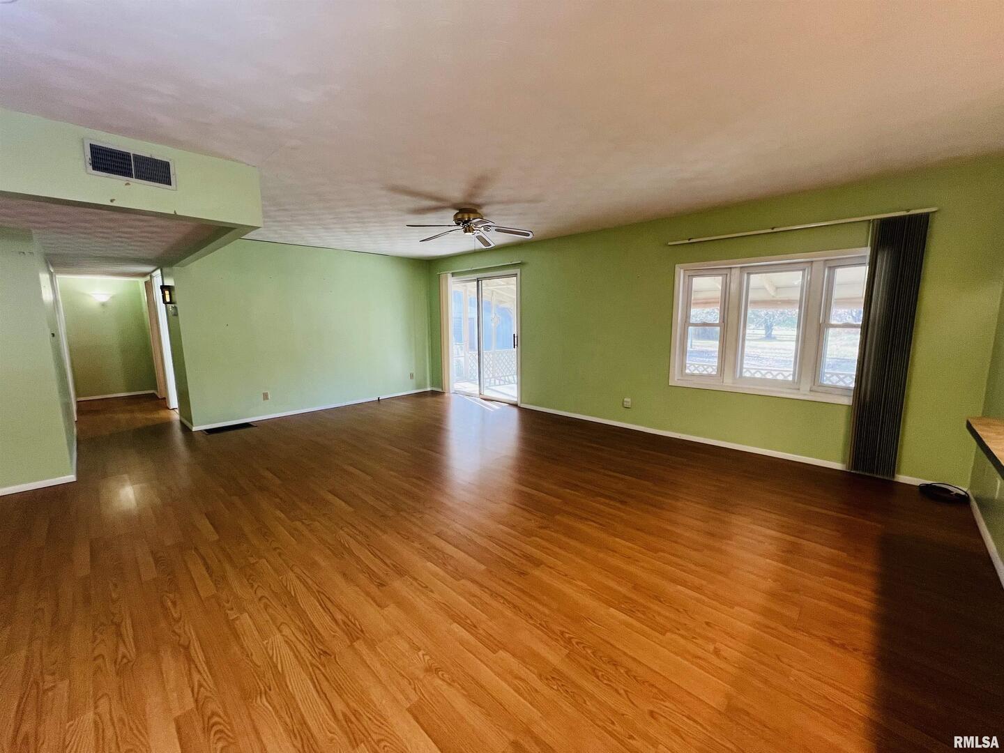 295 Country Acres Road Eldorado, IL 62930 - Photo 23 of 32 a view of empty room with wooden floor and fan