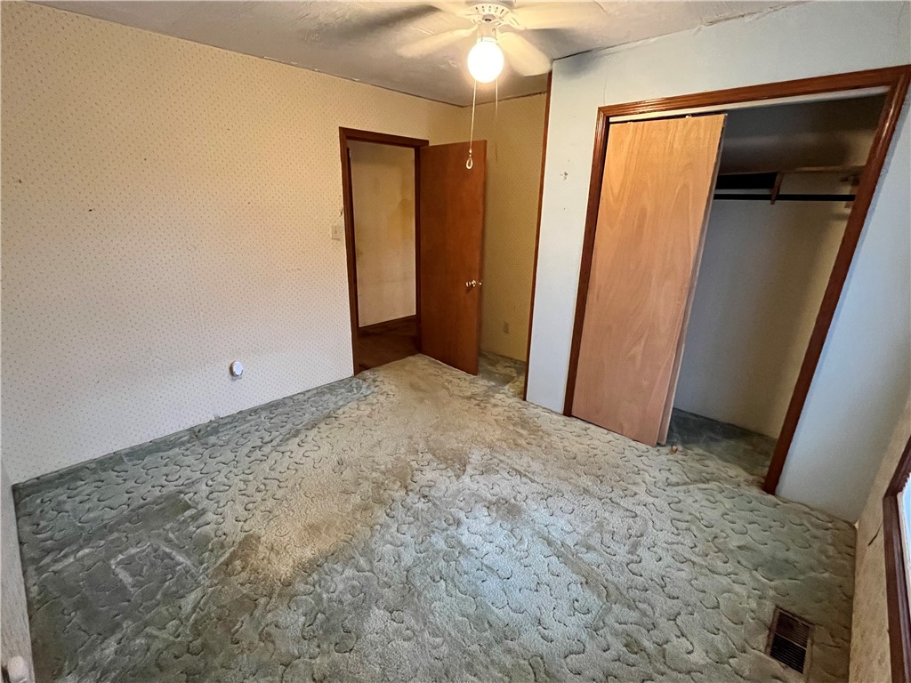 840 Miller Road Ola, AR 72853 - Photo 18 of 23 Unfurnished bedroom featuring a closet and ceiling fan