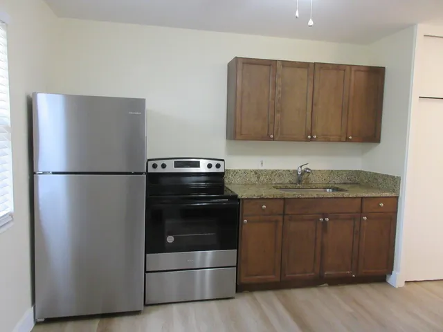a kitchen with a sink and a refrigerator