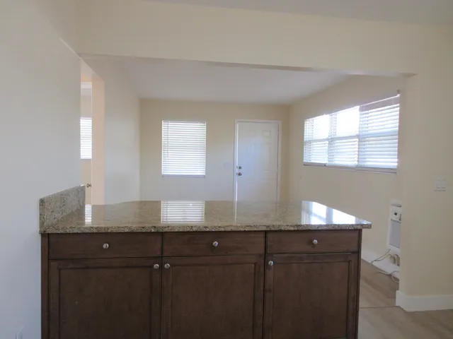 a view of a kitchen counter space and windows