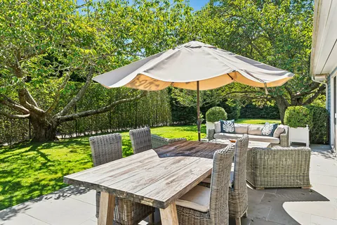 a view of backyard with swimming pool and table