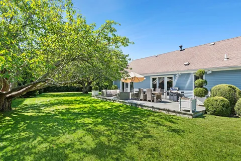 a view of a house with backyard porch and sitting area