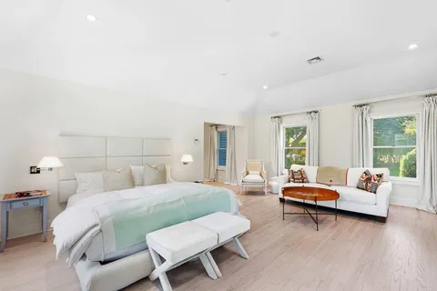 a bedroom with a bed and a couch