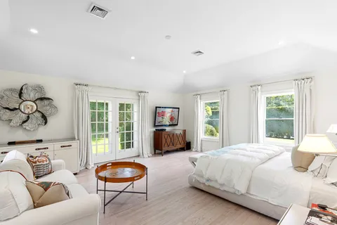 a bedroom with a bed and a couch