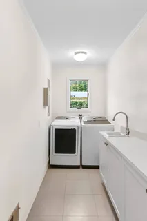 a utility room with sink dryer and washer