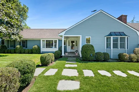 a view of a house with a backyard