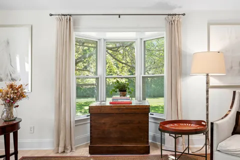 a room with a window and a chair