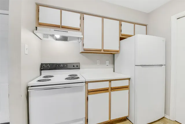 a kitchen with a sink cabinets and window