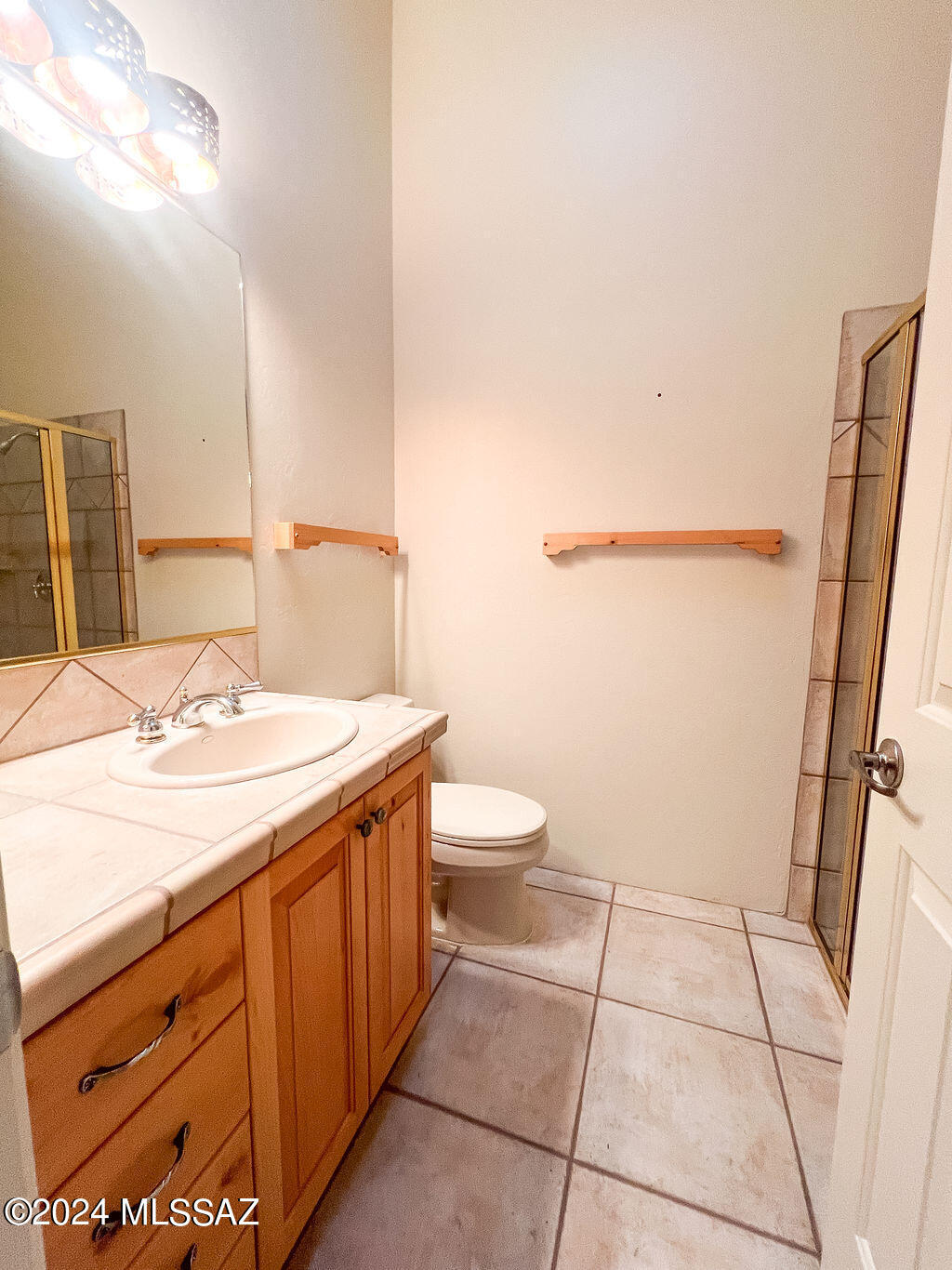 771 West Sedona Ridge Place Oro Valley, AZ 85755 - Photo 22 of 22 a bathroom with a sink a toilet a mirror and vanity
