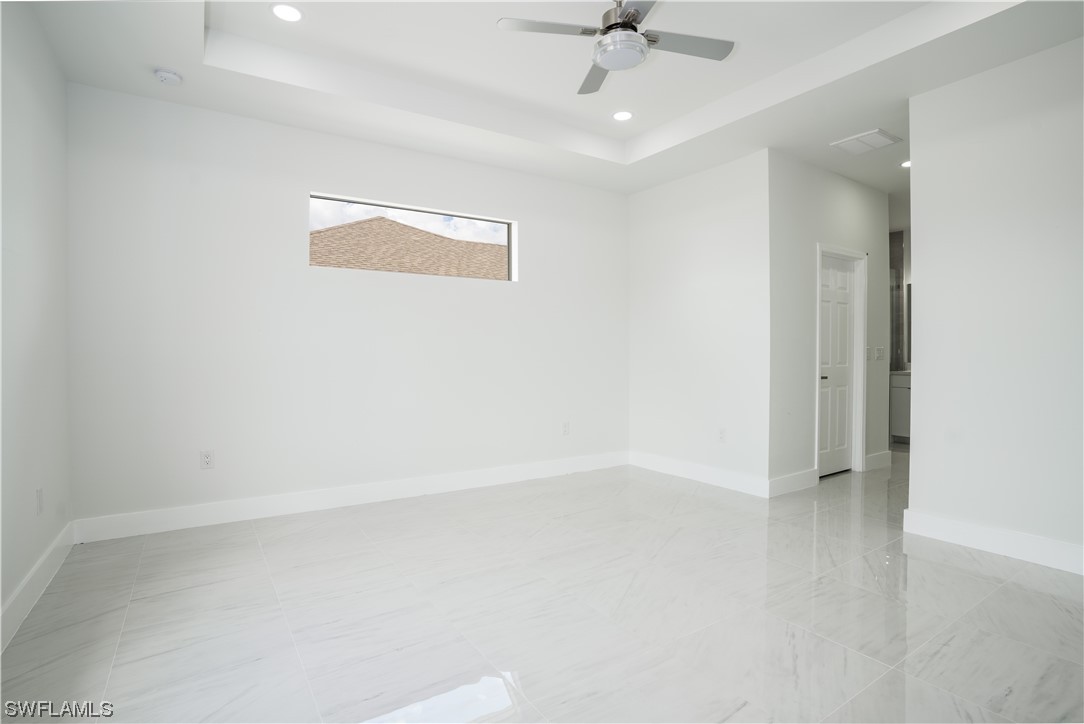 3233 Ruth Lane Lehigh Acres, FL 33976 - Photo 11 of 23 an empty room with a ceiling fan and a window